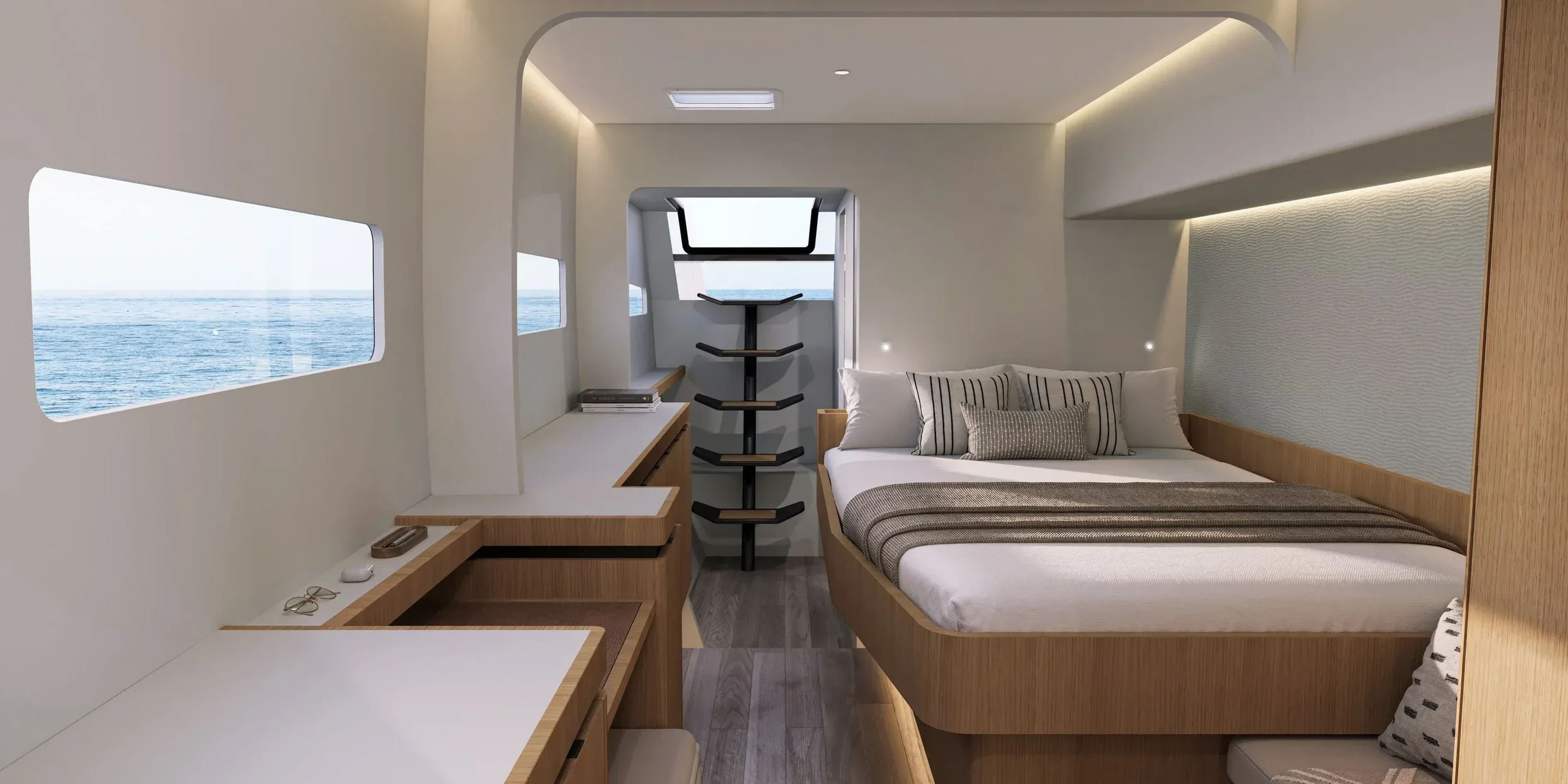 Cabine du Kinetic K6 ouverte sur la mer, bureau et couchage